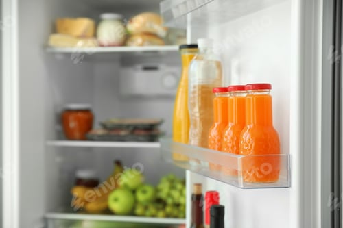 Preview: Bottles of juice on shelf in refrigerator