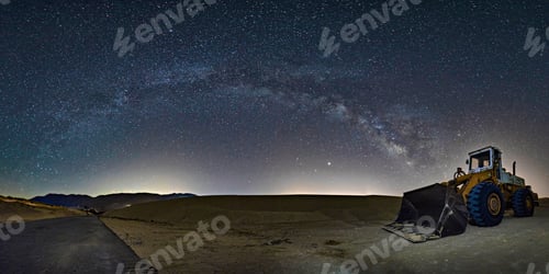Preview: Front loader vehicle in a field under starry night sky