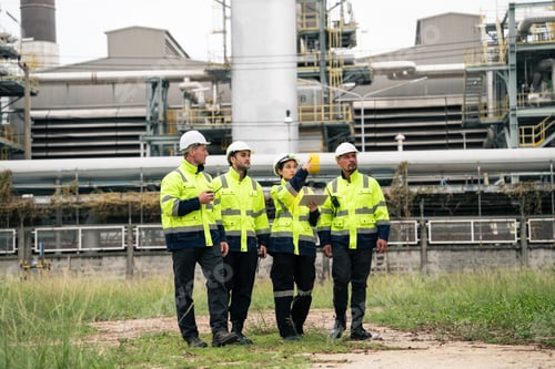 Preview: Group of engineer workers checking project at refinery oil factory