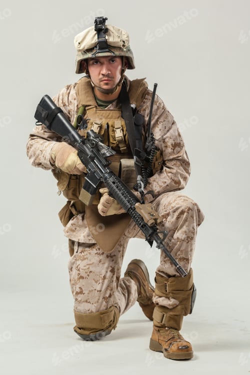 Preview: Soldier in military gear kneeling with weapon indoors during training session