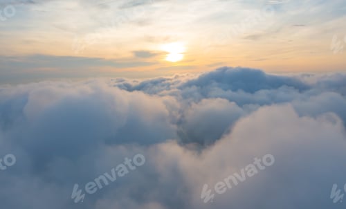 Preview: Aerial view of sunrise above fluffy sea fog misty clouds with mountain hill. Nature landscape