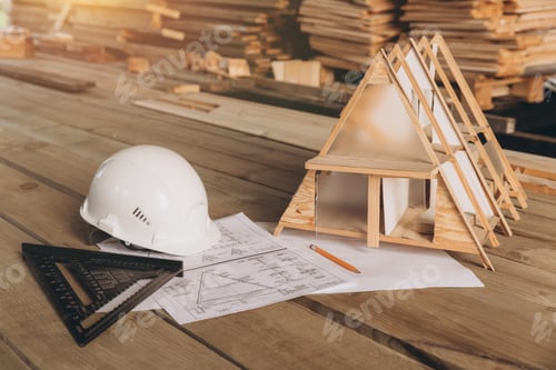 Preview: Architectural office desk with copy space, wooden floor with miniature model of house, white helmet