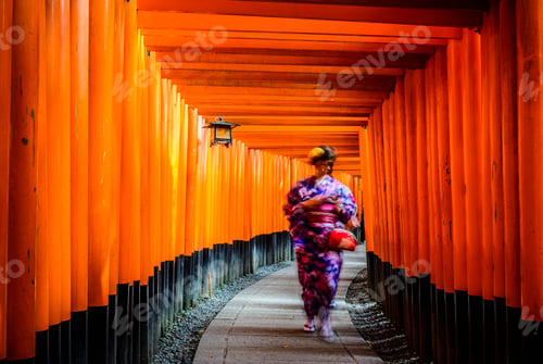 Preview: Woman in kimono walking under wooden pillars