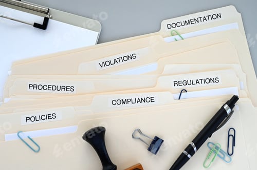 Preview: Compliance, Policies, Regulations, Violations, Procedures and Documentation folders on a desk