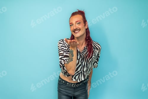 Preview: Non-binary person blowing a kiss on blue background