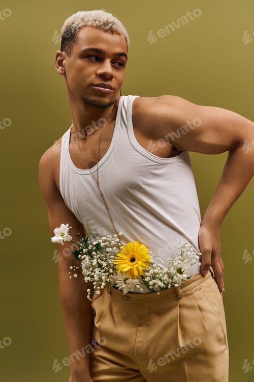 Preview: Young man with dyed hair showcases floral style in vibrant studio setting