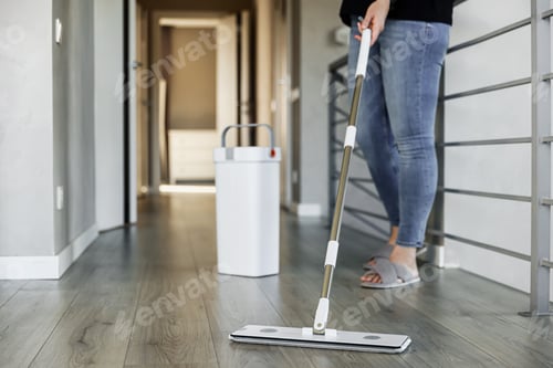 Preview: Woman mopping, wiping floor in home setting. Housewife uses mop, plastic bucket