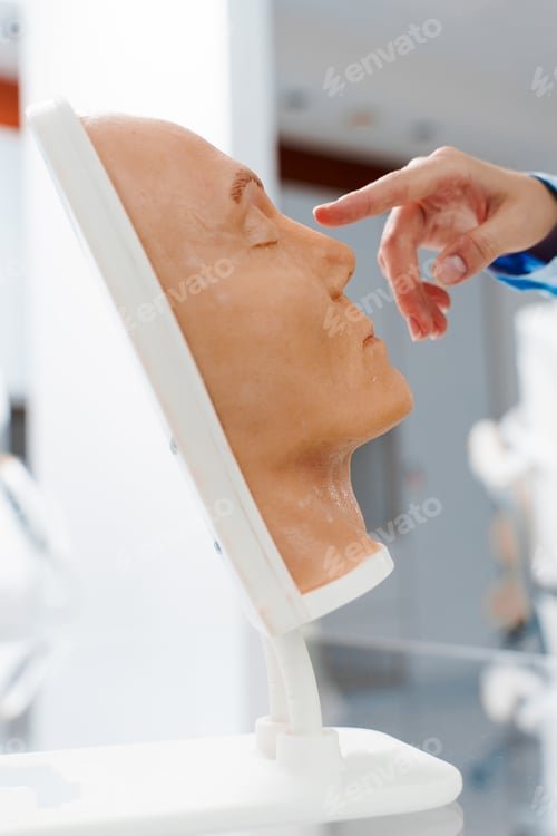 Preview: Rhinoplasty demonstration on mannequin. Human face nose procedure example in clinic