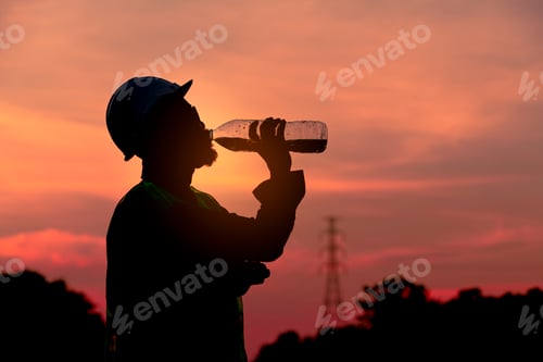 Preview: Silhouette engineer drinking fresh water when he feel thirsty after finish checking and inspection r