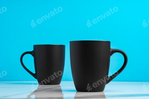 Preview: Two ceramic mugs on blue studio background