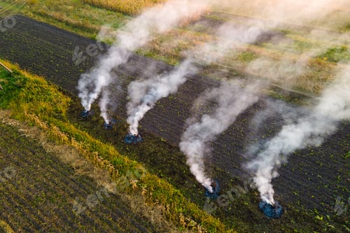 Preview: Aerial view of agricultural waste bonfires from dry grass and straw stubble burning with thick smoke