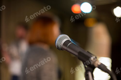 Preview: ↟ Microphone on a blurred background, the people in the club