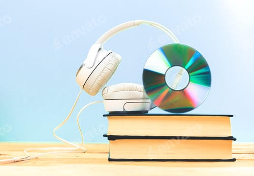 Preview: Books on the table with headphones put on them