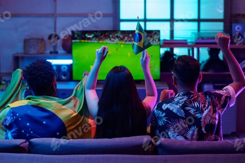 Preview: Multiethnic Young Adults Watching Soccer Match and Celebrating Victory Indoors