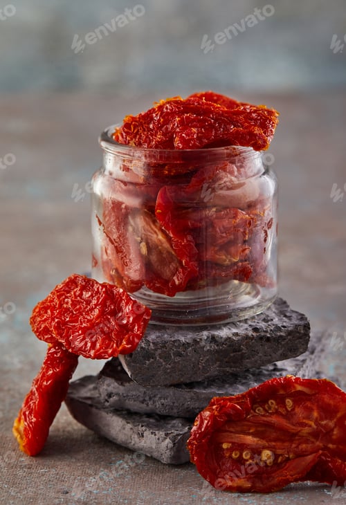 Preview: Fermented vegetarian canned food concept. Pickled dried tomatoes in a glass jar.