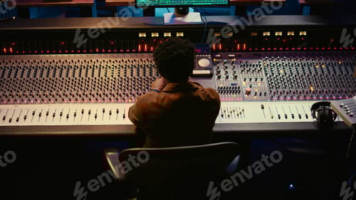 Preview: African american music producer finishing his new track in professional studio