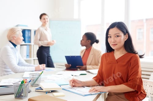 Preview: Asian Businesswoman Posing at Meeting Table