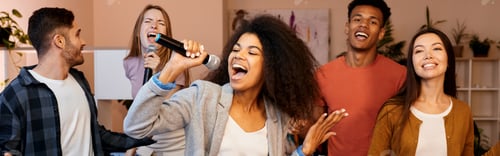 Preview: Singing means happiness. Pretty mixed race girl looking enthusiastic while holding microphone and