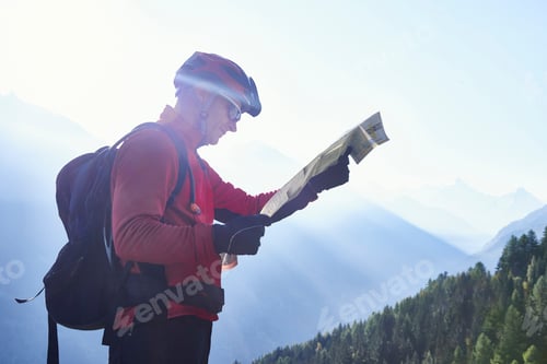 Preview: Mountain biker holding map, Valais, Switzerland
