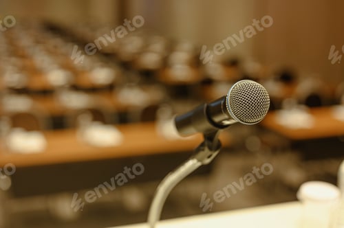 Preview: Close up of microphone on stage in meeting room. Blurred background. Microphone, stage, room, class