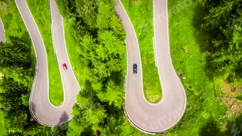 Preview: Cars driving on winding mountain road in the dolomites, italy