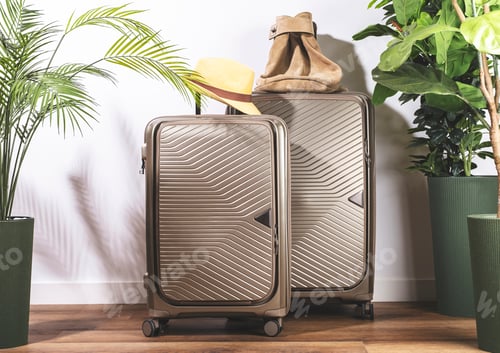 Preview: Elegant beige plastic suitcases on wheels, straw hat and casual backpack