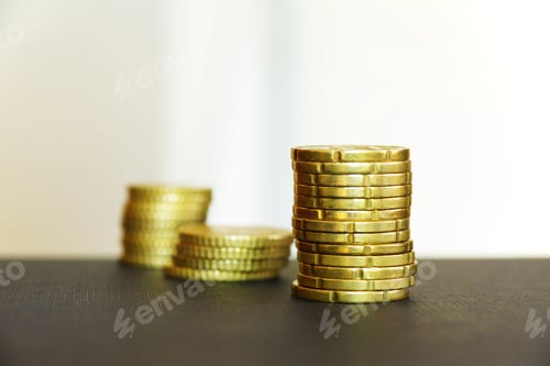 Preview: Stacked Gold Coins on a Dark Surface