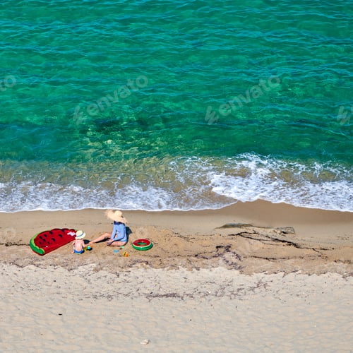 Preview: Two Year Old Toddler Boy And His Mother On Beach With Inflatable Float And Ring. Summer Family