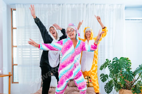 Preview: Beautiful senior women having funny pajama party at home