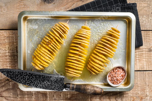 Preview: Uncooked raw Tornado or Twist potato fries. Wooden background. Top view