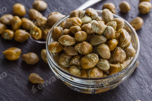 Preview: pickled capers on a dark stone background