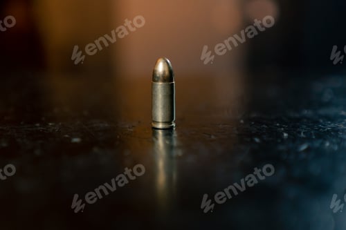 Preview: in a professional shooting range there is a ninth-caliber bullet on a black table introductory