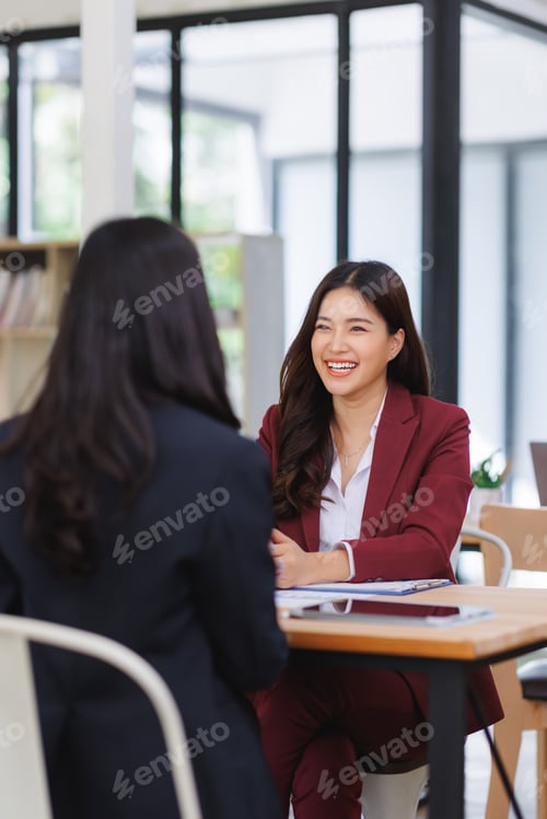 Preview: Happy businesswoman smiling during business meeting discussion