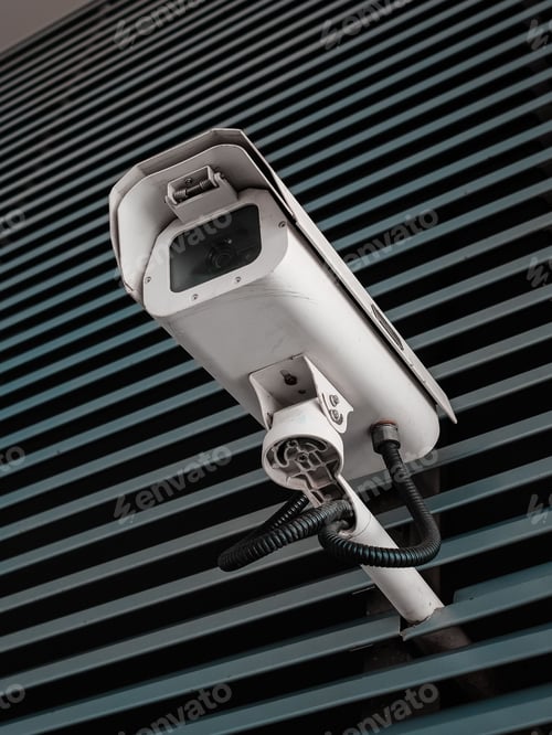 Preview: Security camera installed on a wall of the city.