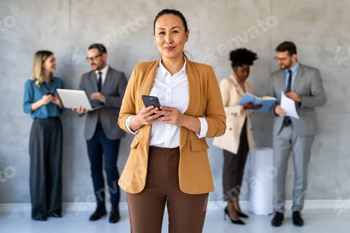 Preview: Group of young business people working as a team and communicating in corporate office