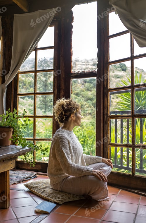 Preview: Side view of woman sitting on the floor at home after finish daily routine of body and mental