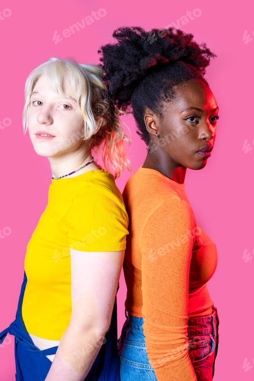 Preview: Two young diverse multicultural caucasian and black women best friends posing isolated background