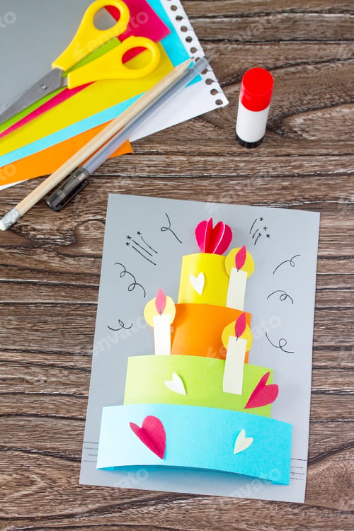 Preview: Greeting card with birthday cake congratulation on a wooden table.