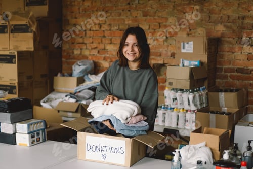 Preview: Volunteer teengirl preparing donation boxes for people.