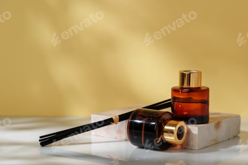 Preview: Luxury Perfume Bottles Elegantly Displayed on Marble Slab Against Golden Background