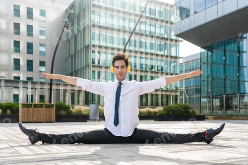Preview: Flexible and cool businessman doing acrobatic trick