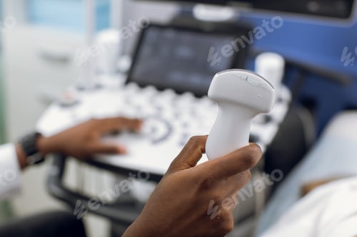 Preview: ultrasound scanner in the hands of male African American doctor