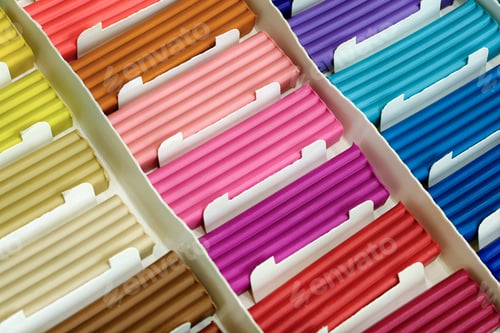 Preview: Pieces of multi-colored plasticine in a cardboard box
