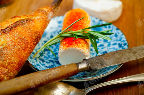 Preview: French cheese and fresh baguette on a wood cutter