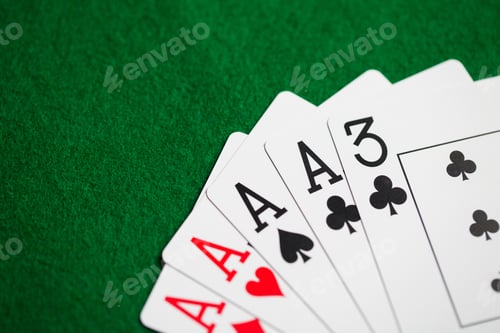 Preview: poker hand of playing cards on green casino cloth