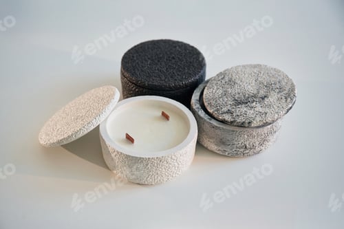 Preview: In capacities. Handmade beautiful decorative candles on the background