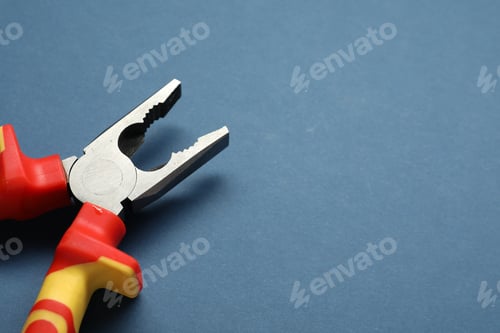 Preview: Combination pliers on blue background, closeup. Space for text