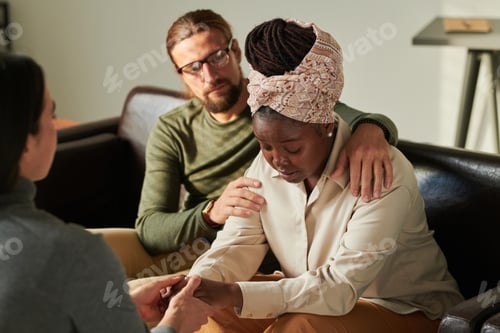 Preview: Depressed couple talking to psychologist at office