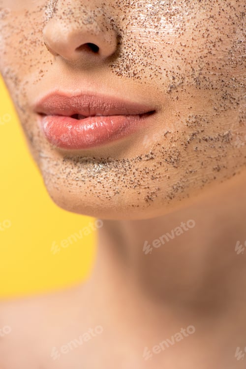 Preview: cropped view of young woman with peeling mask, isolated on yellow