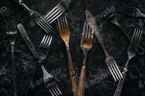 Preview: Old metal forks on rusted background